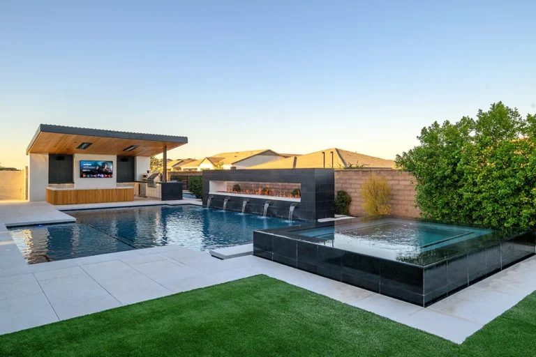 Who We Are Luxury Pool with fireplace and patio bar